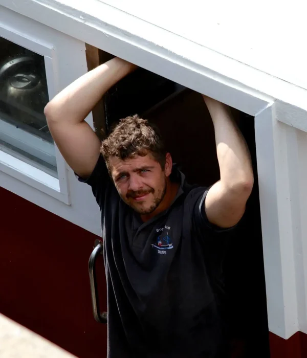 Crab fisherman smiling on boat